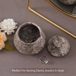 Decorative jewelry box with a ring on a neutral background