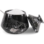 Black marble salt cellar with a spoon on a white background