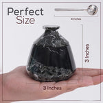 Black marble-textured container held in a hand with measurements shown