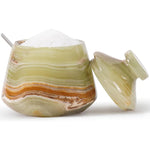 Decorative salt cellar with a spoon on a white background