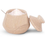 Beige ceramic container with a lid filled with white powder on a white background