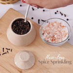 Spice containers with a spoon on a wooden surface, promoting mess-free spice sprinkling.