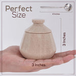 Beige ceramic jar held in a hand with measurements shown