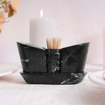 A beige marble onyx salt and pepper shaker set with a tray, displayed on a table with a soft background.